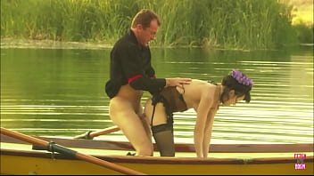 A slim girl jumps on a guys fat cock in a boat on the lake