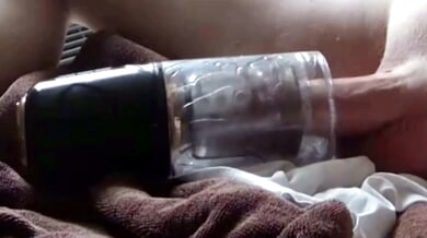 Man pleasures himself with a glass stroker in close-up