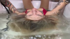 Alina moves her head in the water, making waves (custom video)