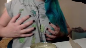 Pear takes a break to roll a joint while her partner whispers softly in her ear.