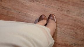 Fifi dangling brown heels and wiggling her toes in nude thigh high nylons