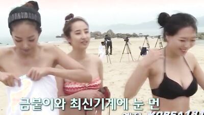 Lovely Asian chicks are getting naked at the public beach