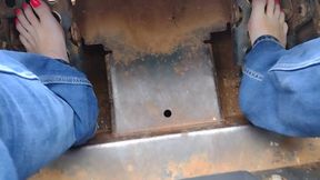 Barefooted babe rides bobcat tractor in public