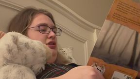 Lonely girl reading to her plushy