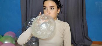 Marianna inflates a glass balloon with balloons inside