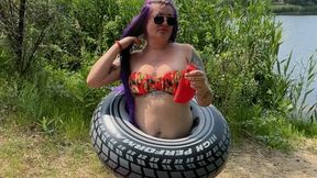 Val in swimring nail pop big red balloon on beach