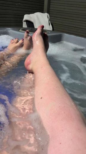 Two dommes feet in the hot tub