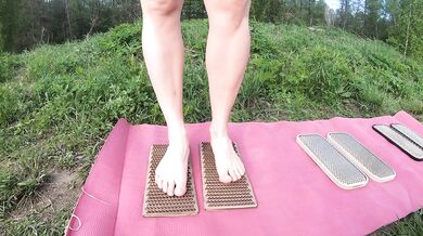naked girl stands on nails