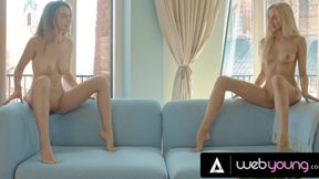A couple of hot lesbians tease each other on the couch