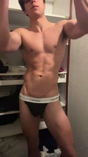 bodybuilder posing in a tight thong