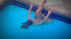 Woman playing with pool jet