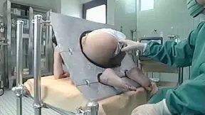 Asian big ass MILF  in a machine takes an enema pretty well