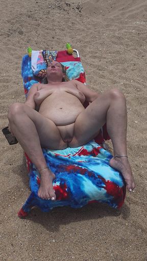 Laying with my shaved pussy spread wide open on nude beach to tease those walking by and looking. BBW swinger wife feet