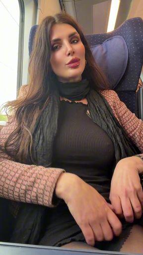 Curvy brunette sits alone on a train in her professional attire