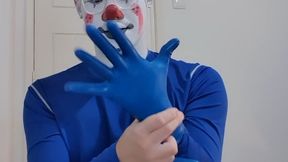 Clown putting on blue rubber gloves