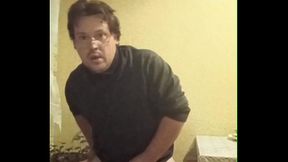 A tattooed gay man in glasses is riding a cucumber!