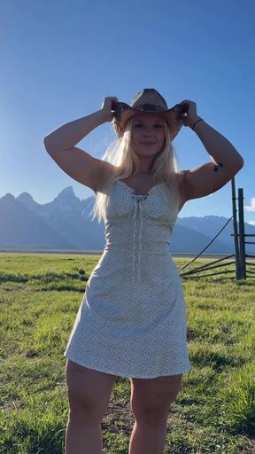 Woman in cowboy hat posing outdoors