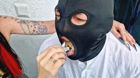 Dominatrix smokes on the balcony and uses a man as her ashtray