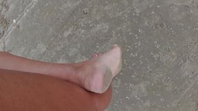 Strolling barefoot on the beach and street, feet in the sand - foot obsession