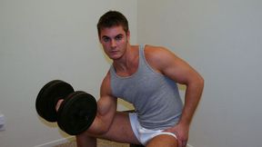 Brenden is jacking off furiously on a bed