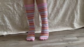 Showing my colorful long socks and taking them off of my feet slowly, teasing