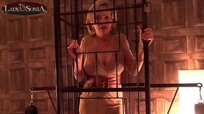 Lady Sonia caged and strips nude in the sex dungeon