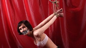 Tapegagged barefoot Blackshark, kneeling under the rack with her feet tied together and her hands in strappado, wiggles and wriggles (HD MOV)