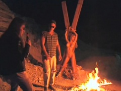 Cultists sacrifice a fine blonde during a sensual fire ritual
