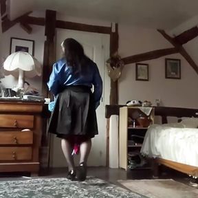 In a black skirt outfit with a royal blue lavaliere blouse and tie