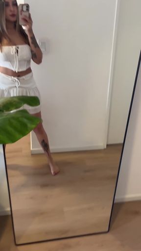 Blonde woman in white tank top and denim shorts