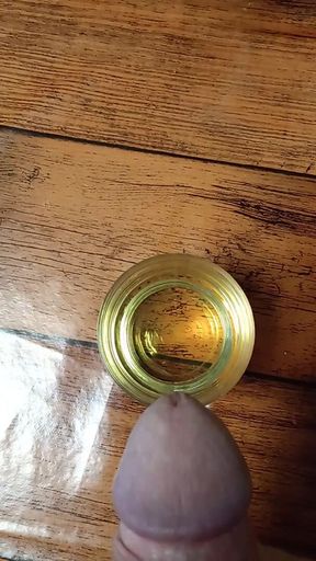 Cumming in a glass of sunflower oil