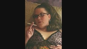 Laying down in a leopard print jumper smoking a full flavor Virginia Slims 100