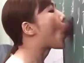 Seductive Japanese Teacher Engages in Steamy Glory Hole Action
