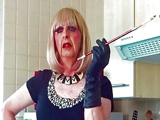 Glamorous Granny tranny Mandy smoking with sexy holder