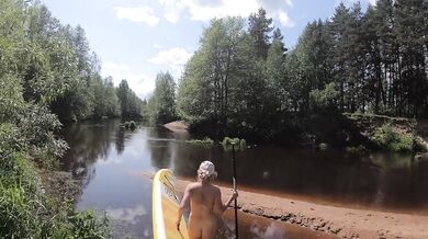 Naked girl on a hiking trip on a SUP board