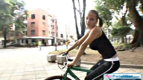 Busty teen riding her bike through the park