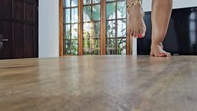 Balbina The Queen of the Big Feet modeling her big soles on the table