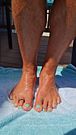 Showing off my oiled tanned legs and new pedicure with toe ring