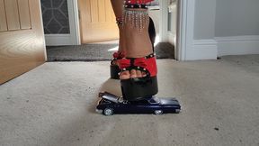 Nikkichick crushes a 1962 Buick Electra 22 in big stiletto heels toy car crush close up ground view