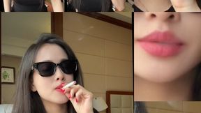 Stunning Asian girl Lucy exudes elegance and charm as she smokes. With stylish black sunglasses, vibrant red lips, and long red nails, she takes slow, sensual drags, letting the smoke swirl around her. The perfect mix of cool, sexy, and irresistibly