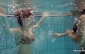 Mia and Petra undress eachother in the swimmingpool