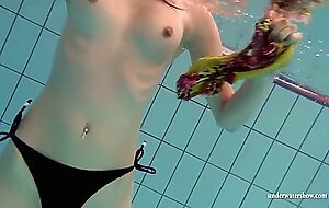 Mia and Petra undress eachother in the swimmingpool