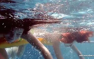 Mia and Petra undress eachother in the swimmingpool