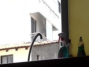 Sexy man smoking a cigarette and flashing his blonde neighbour