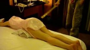 Submissive brunette wife lies on her belly while getting her ass spanked