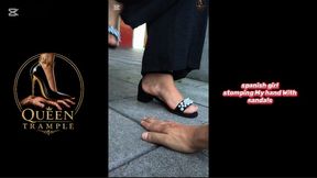 girl stomping My hand With black sandals