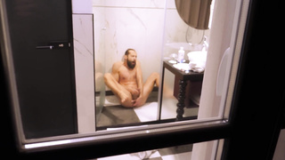 Mature boy filmed from outside while taking a bathroom and wanking off his rock hard wood