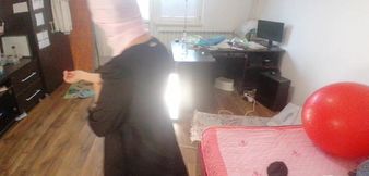 Amateur woman has fun trying on clothes and cutting them.