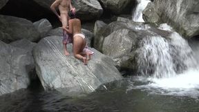 Beautiful waterfall made two teens horny and they climbed on a rock to have sex there