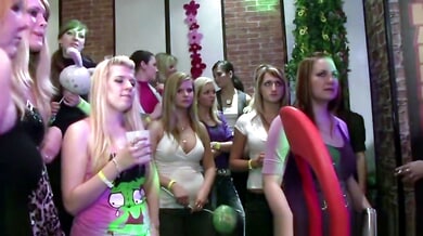 Blonde and redhead perform oral sex at a crowded nightclub party